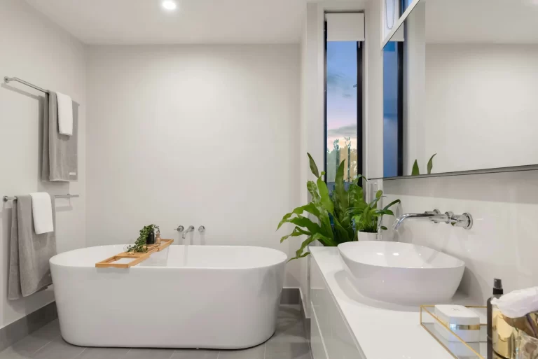 Modern bathroom featuring a large window and a stylish tub, highlighting budget-friendly remodeling options.